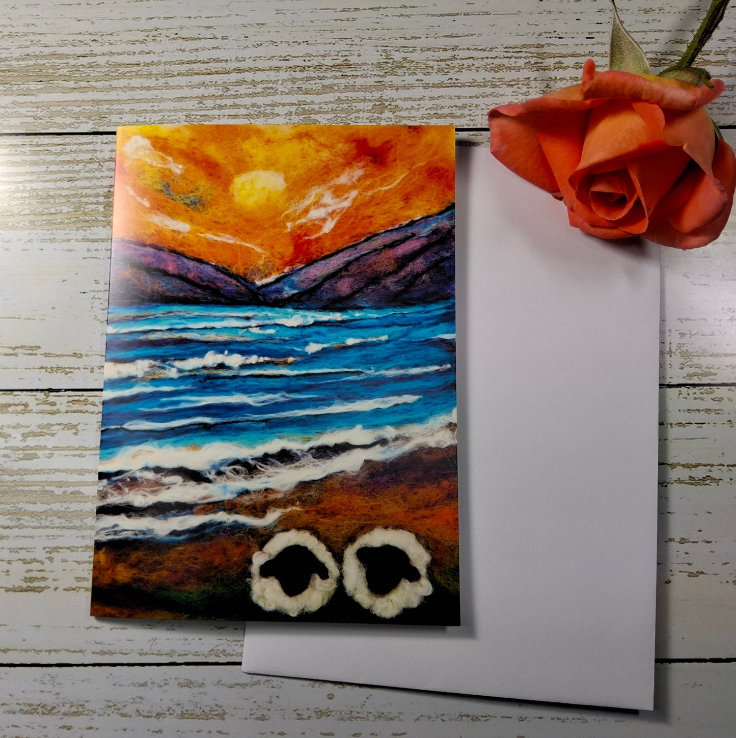 A square art print or card featuring a colorful seascape painting with a yellow sun, blue ocean,