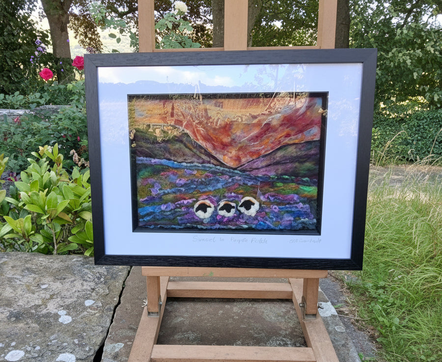 A framed textured painting of three ducks in a pond under a warm orange sky, displayed on a wooden easel outdoors in a garden setting.